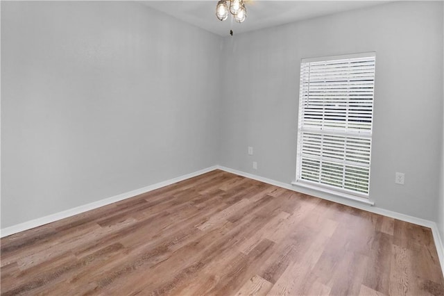 empty room with hardwood / wood-style flooring and ceiling fan