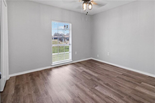 empty room featuring dark hardwood / wood-style floors and ceiling fan