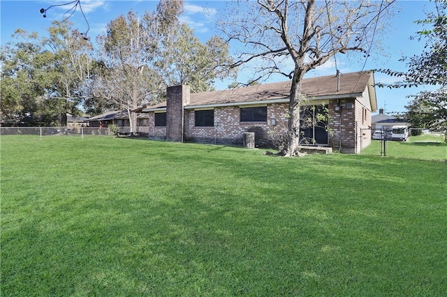 rear view of property with a lawn