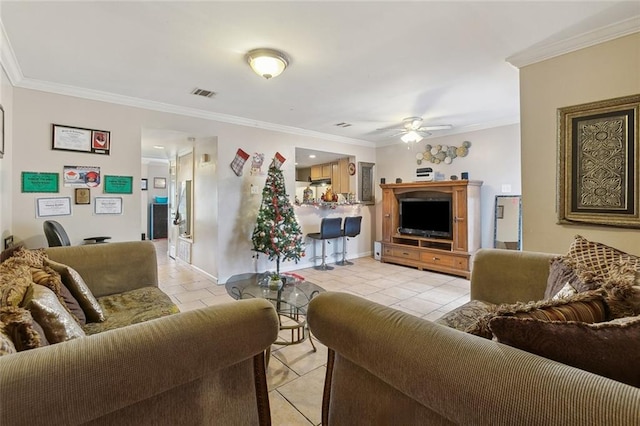 living room with ceiling fan, crown molding, and light tile patterned flooring