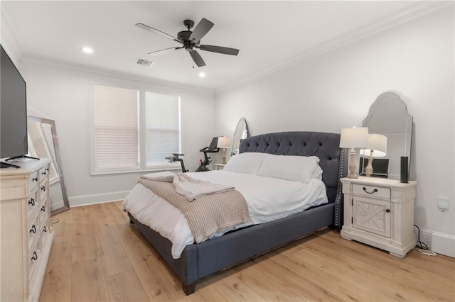 bedroom with crown molding, light hardwood / wood-style floors, and ceiling fan