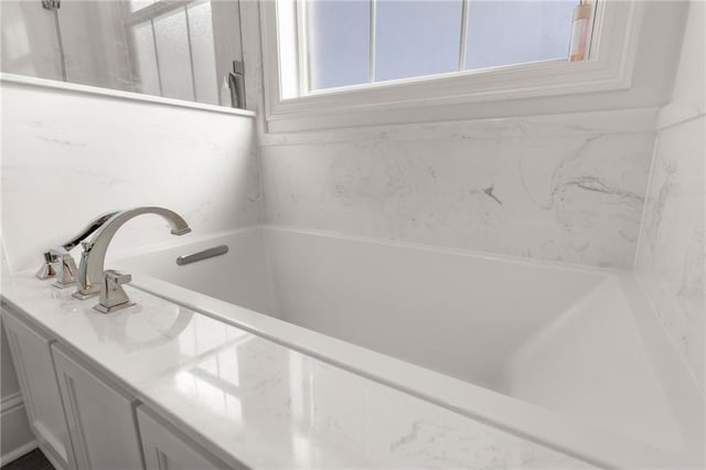 bathroom featuring a relaxing tiled tub