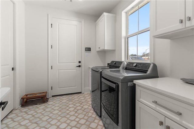 laundry area with cabinets, washer and dryer, and plenty of natural light