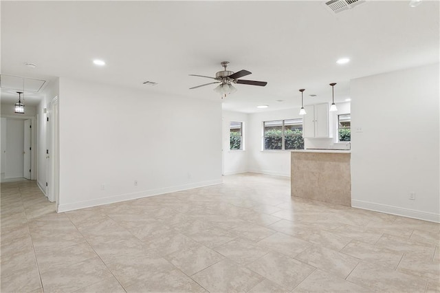 unfurnished living room featuring ceiling fan