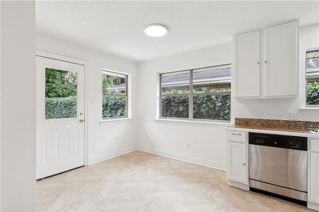 kitchen featuring white cabinetry and dishwasher