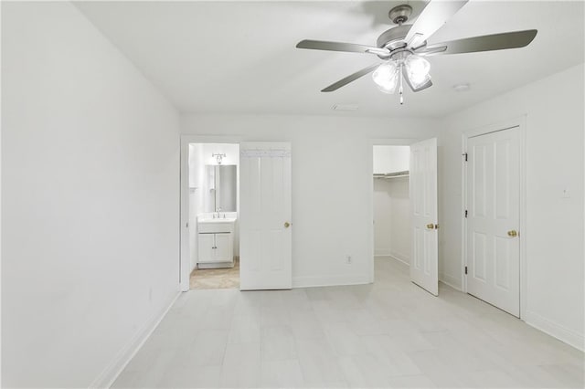 unfurnished bedroom featuring connected bathroom and ceiling fan