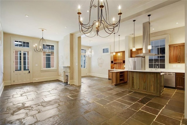 kitchen featuring pendant lighting, a center island, a chandelier, island exhaust hood, and stainless steel appliances