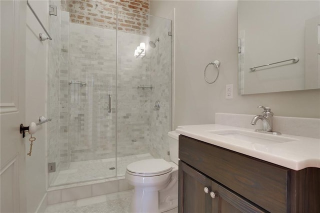 bathroom with vanity, toilet, and a shower with door