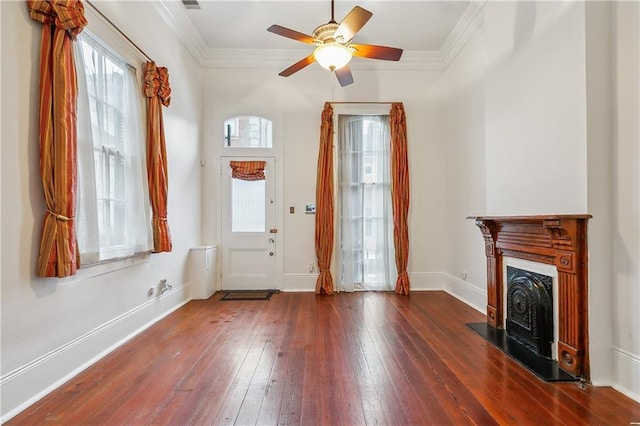 doorway to outside with dark hardwood / wood-style flooring, ceiling fan, and crown molding