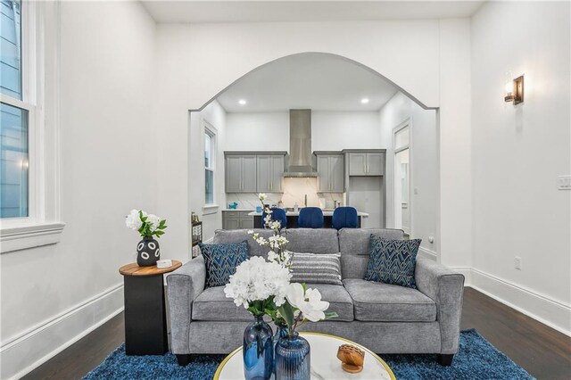 2417 Royal St, New Orleans, LA 70117 - living area featuring arched walkways, dark wood-style flooring, and recessed lighting