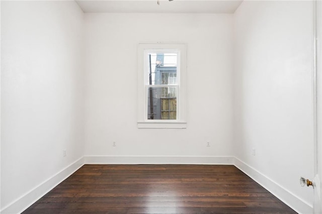 spare room featuring dark wood-type flooring