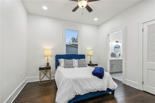 bedroom featuring ceiling fan, dark wood-type flooring, and ensuite bath