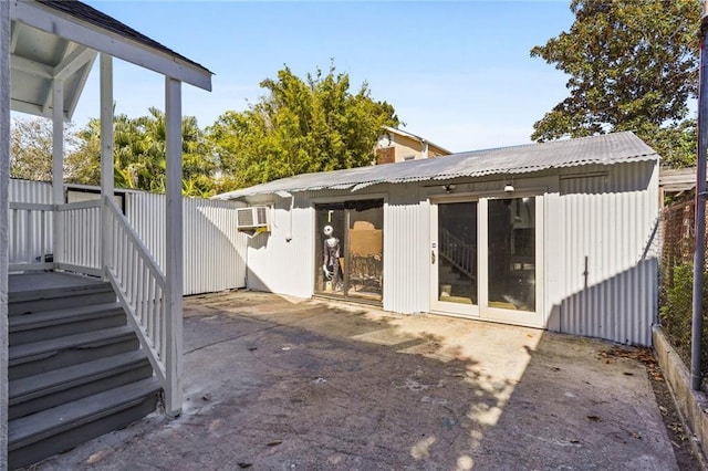 back of house with a patio and an outdoor structure