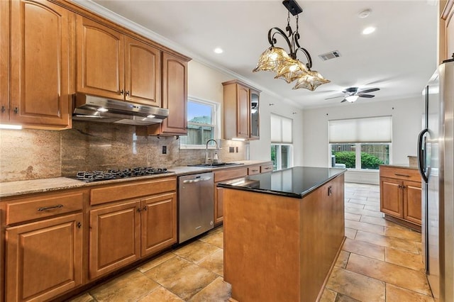 kitchen featuring a center island, decorative backsplash, ceiling fan, dark stone countertops, and stainless steel appliances