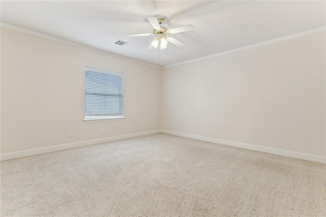 carpeted empty room featuring ceiling fan and crown molding