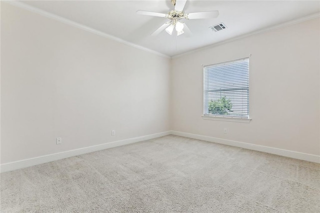 carpeted empty room with ceiling fan and crown molding