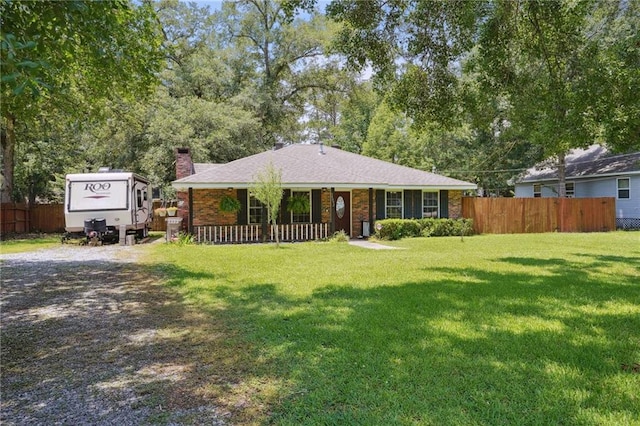 ranch-style home featuring a front yard