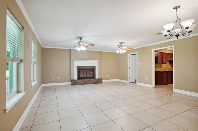 unfurnished living room with ceiling fan with notable chandelier, crown molding, and light tile patterned flooring