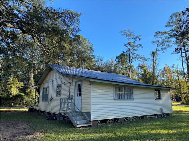 rear view of house featuring a yard