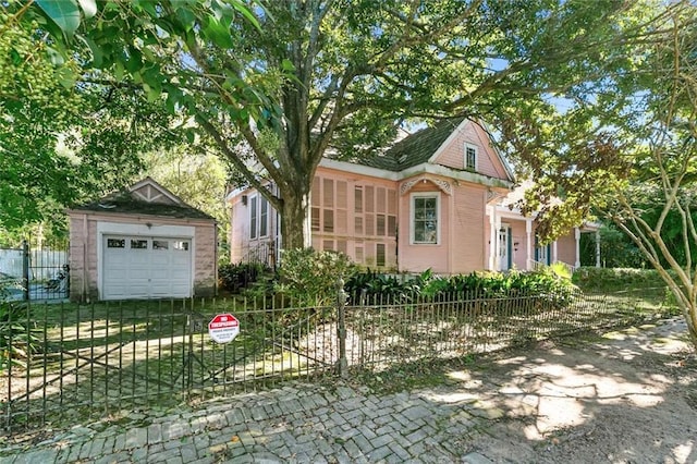 view of front of property featuring an outdoor structure and a garage