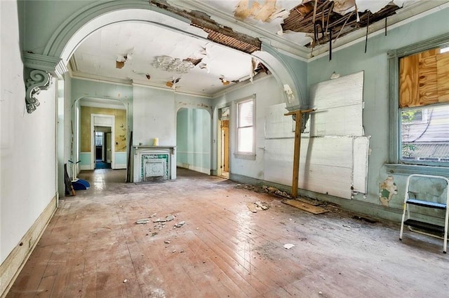 misc room with hardwood / wood-style flooring, ornamental molding, and a wealth of natural light