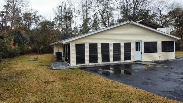 exterior space featuring a lawn and cooling unit