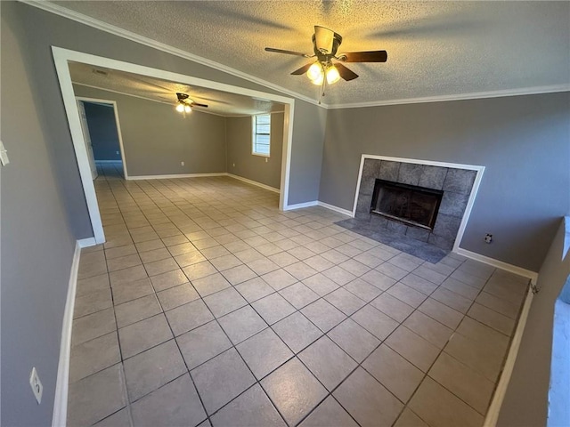 unfurnished living room featuring light tile patterned floors, a fireplace, ornamental molding, and a ceiling fan