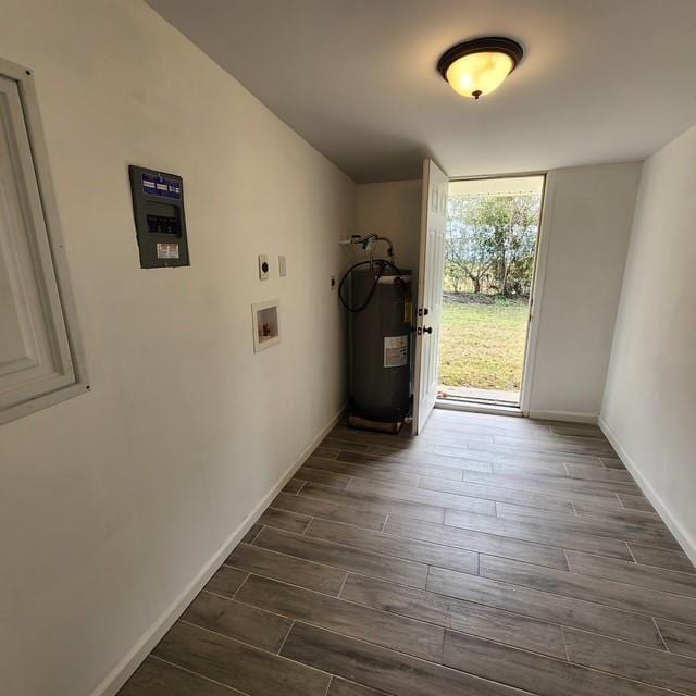 interior space featuring wood tiled floor, water heater, and baseboards