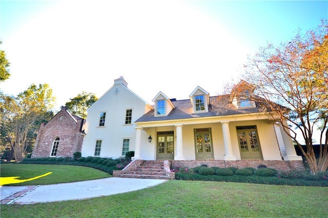 view of front of house with french doors and a front yard