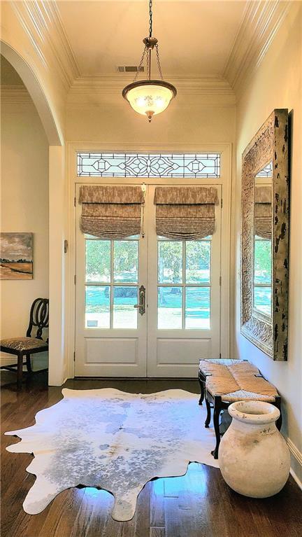 doorway featuring french doors, wood-type flooring, and ornamental molding