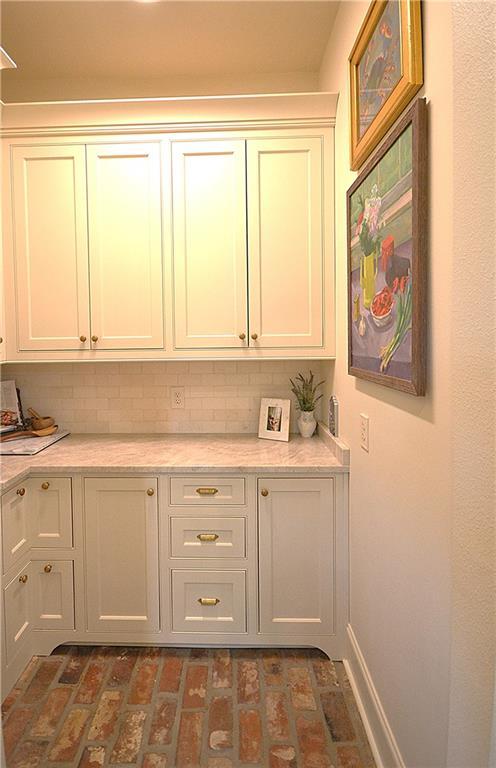 bar featuring white cabinets and decorative backsplash