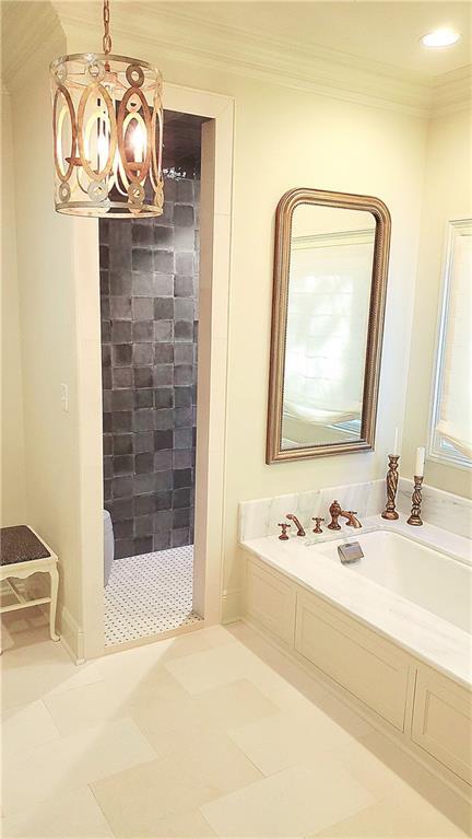 bathroom featuring a chandelier, shower with separate bathtub, tile patterned flooring, and crown molding