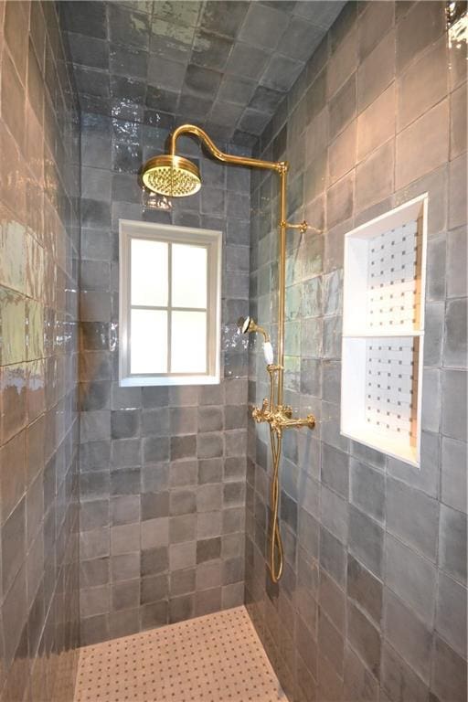 bathroom with a tile shower