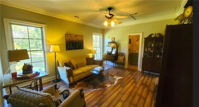 living room with ceiling fan, ornamental molding, and dark wood-type flooring