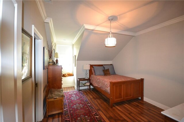 bedroom featuring dark hardwood / wood-style floors, vaulted ceiling, and ornamental molding