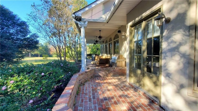 view of patio with area for grilling and ceiling fan