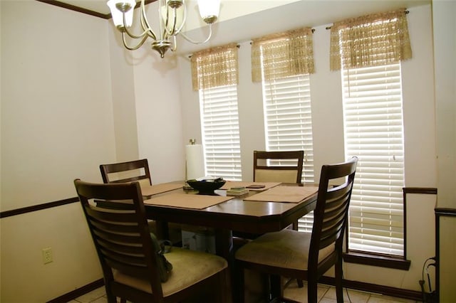 dining area with light tile patterned floors and an inviting chandelier