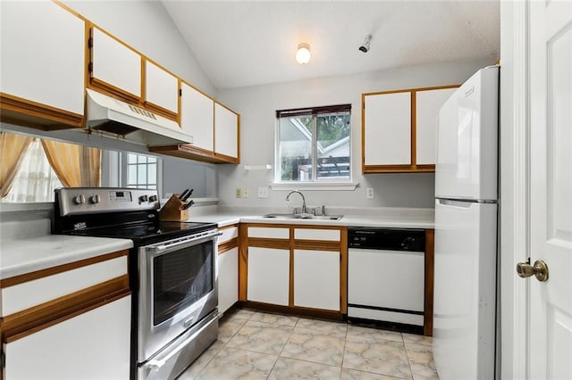 kitchen with white appliances, white cabinetry, vaulted ceiling, and sink