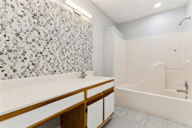 bathroom featuring tile patterned flooring, vanity, and shower / bathtub combination