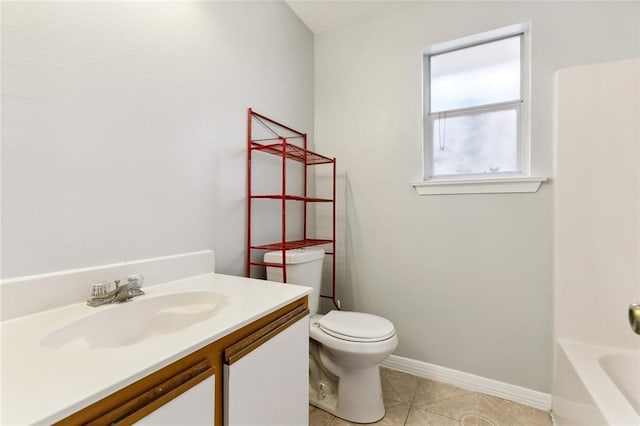 bathroom featuring tile patterned flooring, vanity, toilet, and a washtub