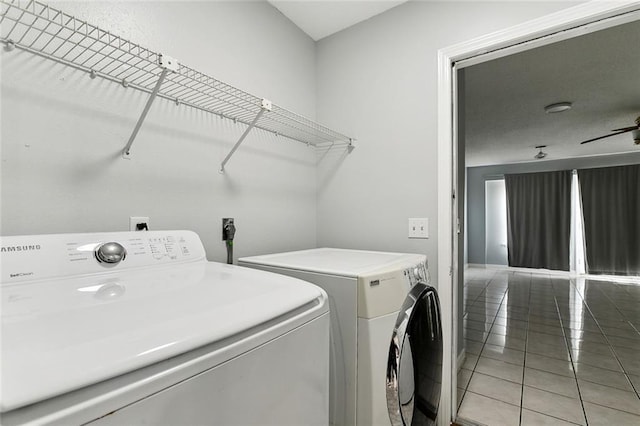 clothes washing area with tile patterned floors and washer and dryer