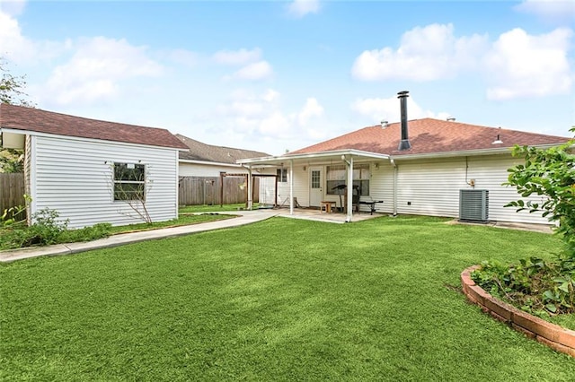 back of house featuring a patio area, a yard, and central AC unit