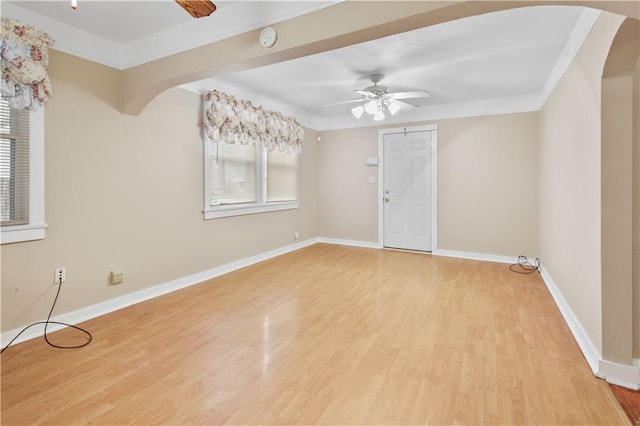 spare room featuring wood-type flooring, a wealth of natural light, and ceiling fan