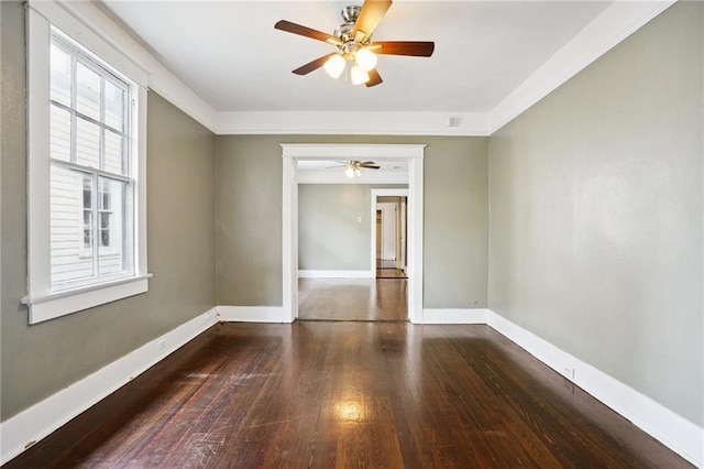 empty room featuring ceiling fan and dark hardwood / wood-style flooring