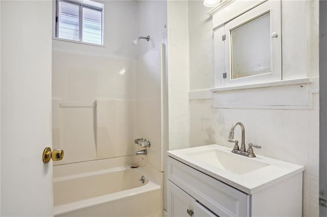 50507 Passera Ct, New Orleans, LA 70119 - bathroom featuring tub / shower combination, vanity, and tile walls