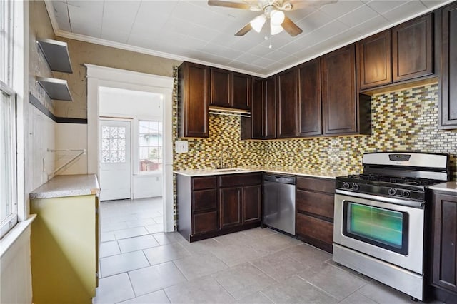 50507 Passera Ct, New Orleans, LA 70119 - kitchen with stainless steel appliances, a ceiling fan, light countertops, backsplash, and crown molding