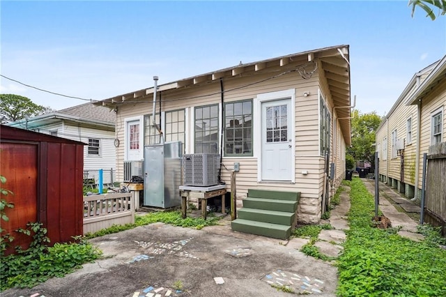 rear view of property with a patio area and a storage shed