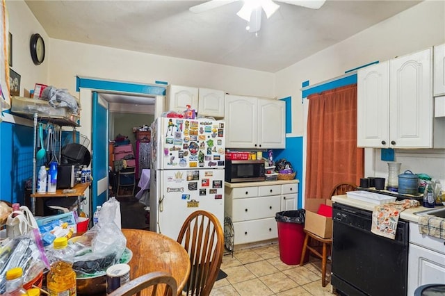 50507 Passera Ct, New Orleans, LA 70119 - kitchen with freestanding refrigerator, stainless steel microwave, black dishwasher, white cabinets, and ceiling fan