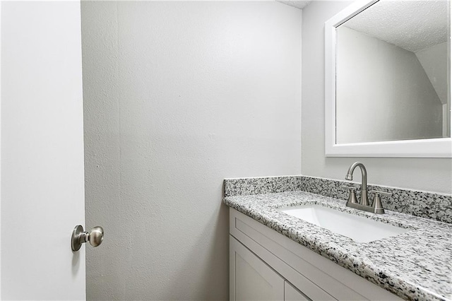 bathroom featuring vanity and a textured ceiling