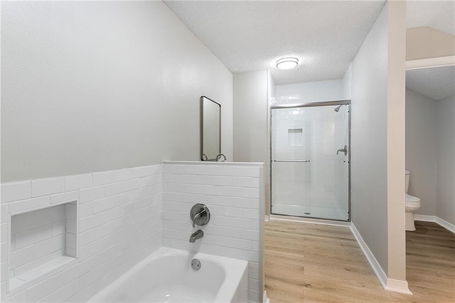 bathroom with toilet, wood-type flooring, and a textured ceiling